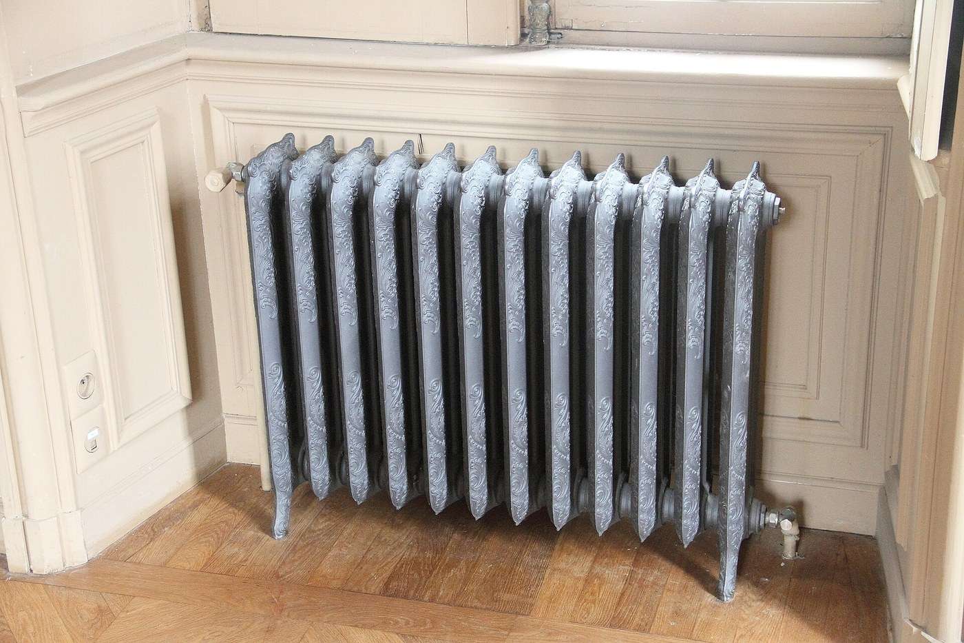 En støbejernsradiator i et ældre hus: med fyret kørte den ved 70-80 °C, med en varmepumpe er mindre ofte nok